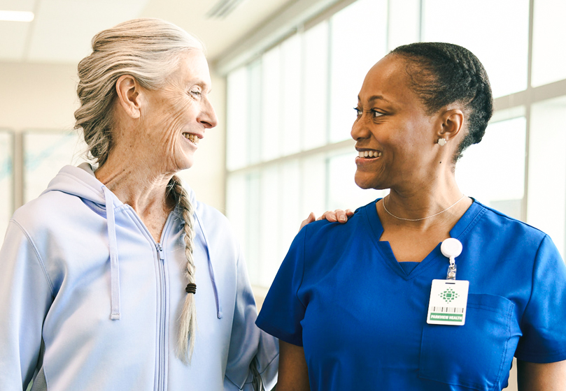 Nurse and patient smiling at one another