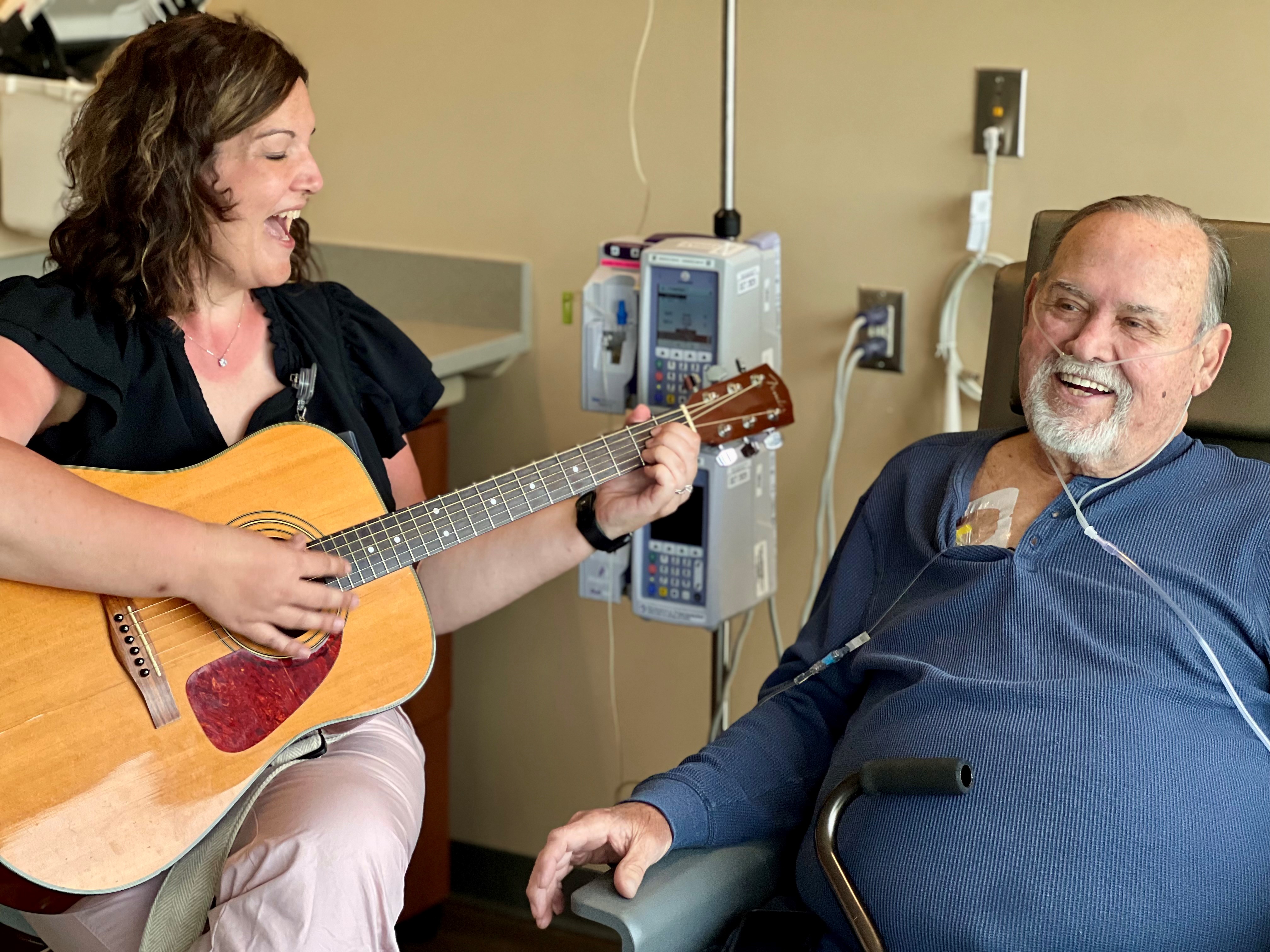 Music therapist and patient smiling
